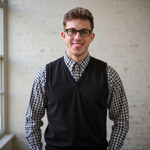 Showcase image for Engaging The Audience - Prompt: a photo of me MAN as a keynote speaker, medium shot, smiling warmly at the (implied) audience, open and inviting posture. MAN looking approachable.