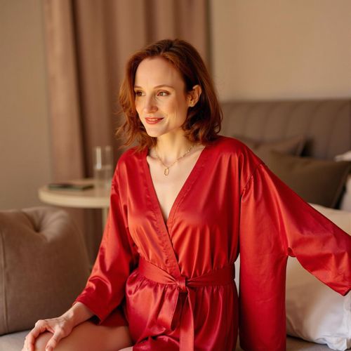 Showcase image for Satin Allure - Prompt: a photo of me WOMAN in a red satin robe, medium shot, playfully revealing lingerie, luxurious setting. WOMAN with a confident smirk.