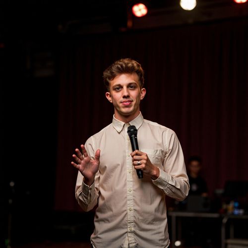 Showcase image for Inspirational Speaker - Prompt: a photo of me MAN as an inspirational speaker, medium shot, with an uplifting, hopeful expression, warm stage lighting. MAN looking motivating.