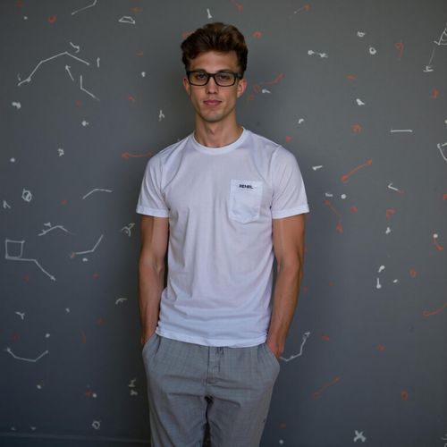 Showcase image for Tech Innovator - Prompt: a photo of me MAN in modern, minimalist attire, medium shot, against a backdrop with subtle tech-related geometric patterns. MAN looking visionary.