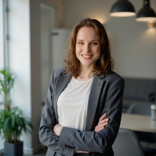 a photo of me WOMAN in smart business casual attire, medium shot, against a modern office backdrop, looking innovative. WOMAN with a friendly, confident smile.