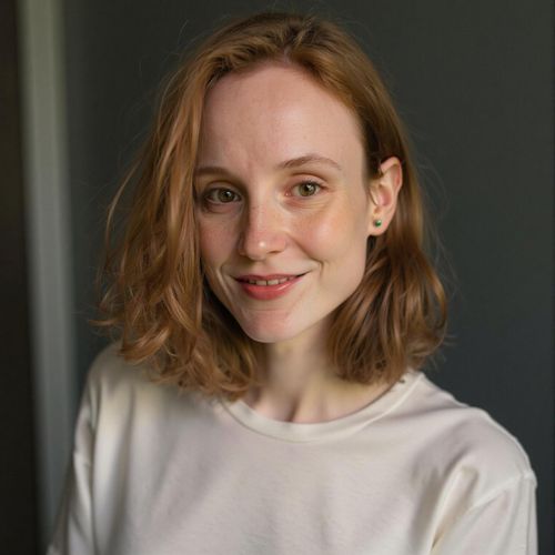 Showcase image for Natural & Real - Prompt: a photo of me WOMAN, natural actor headshot, medium close-up, minimal makeup, simple t-shirt, showing true essence. WOMAN looking directly at camera, honest expression.