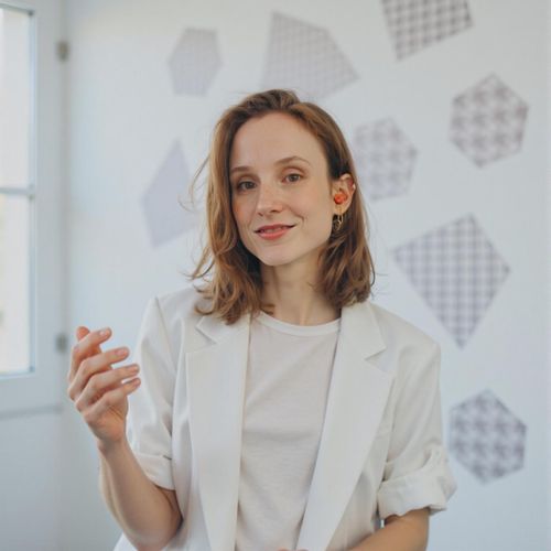 Showcase image for Tech Innovator - Prompt: a photo of me WOMAN in modern, minimalist attire, medium shot, against a backdrop with subtle tech-related geometric patterns. WOMAN looking visionary.