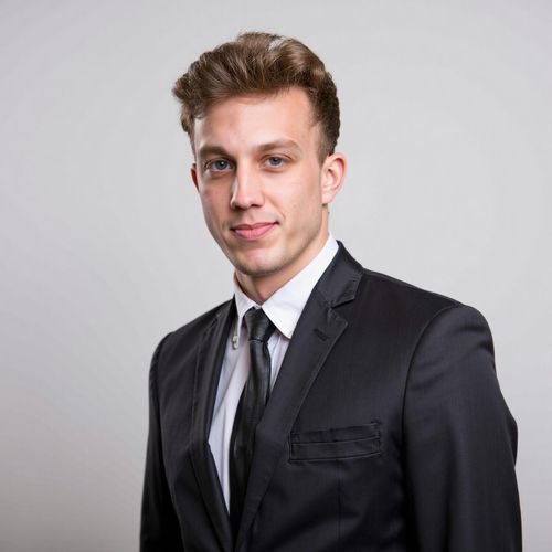 a photo of me MAN in a sharp business suit, classic headshot, plain studio background, looking confident. MAN making direct eye contact.