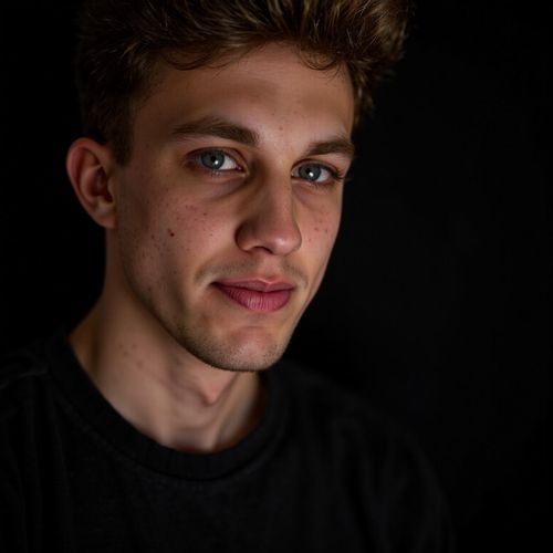 Showcase image for Dramatic Shot - Prompt: a photo of me MAN, dramatic actor headshot, close-up, conveying deep sorrow through the eyes, soft, moody lighting. MAN looking heartbroken.