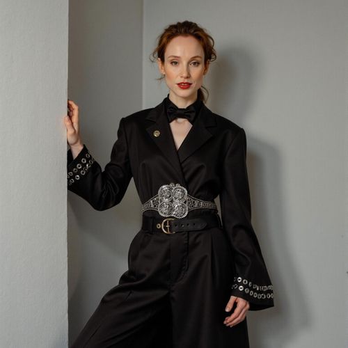 Showcase image for Editorial Chic - Prompt: a photo of me WOMAN in an avant-garde outfit, medium shot, artistic pose, fashion magazine editorial style. WOMAN with a strong, expressive look.