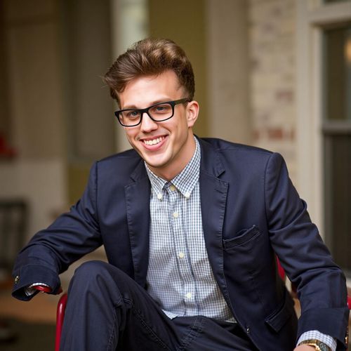 Showcase image for Engaging The Audience - Prompt: a photo of me MAN as a keynote speaker, medium shot, smiling warmly at the (implied) audience, open and inviting posture. MAN looking approachable.