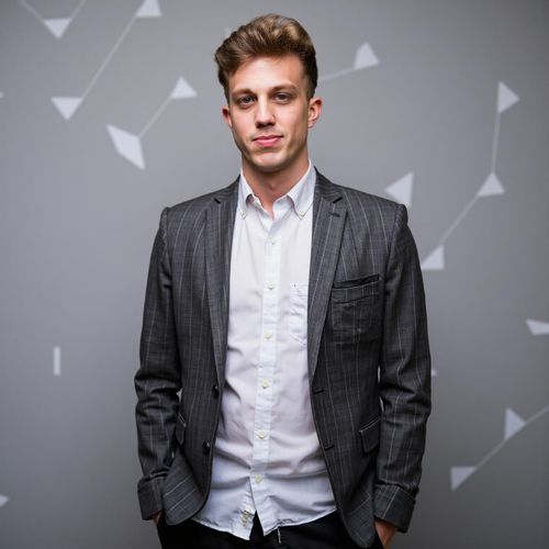 Showcase image for Tech Innovator - Prompt: a photo of me MAN in modern, minimalist attire, medium shot, against a backdrop with subtle tech-related geometric patterns. MAN looking visionary.