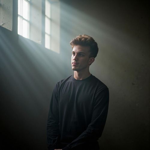 a photo of me MAN in a smoky room, the light filtering through in beams, half body shot. MAN looking contemplative.