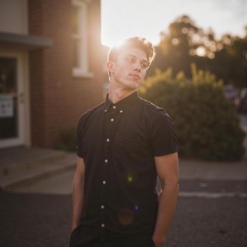 Showcase image for Nature Connection - Prompt: a photo of me MAN with their face turned towards the sun, eyes closed, half body shot. MAN absorbing the light.