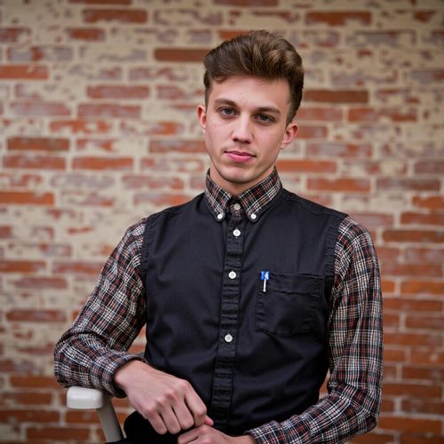 a photo of me MAN in artistic attire, medium close-up shot, against a textured unique background, showing individuality. MAN with an engaging, creative expression.