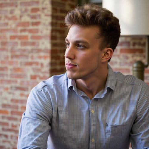 Showcase image for Candid Moment - Prompt: a photo of me MAN in a relaxed pose, half body shot, looking thoughtfully off-camera, yearbook candid style. MAN captured in a natural moment.