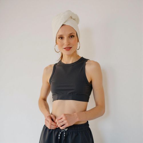 a photo of me WOMAN in high-end athletic wear, half body shot, clean, minimalist background, looking like a fitness model. WOMAN with a confident posture.