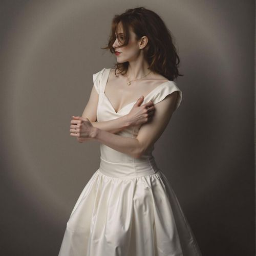 a photo of me WOMAN, elegantly dressed, half body shot, partially obscured by shadow. WOMAN looking alluring and dangerous.