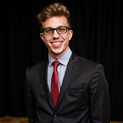 Showcase image for Post-Talk Power Shot - Prompt: a photo of me MAN backstage after a keynote, medium shot, looking confident and pleased, slight smile of accomplishment. MAN exuding success.