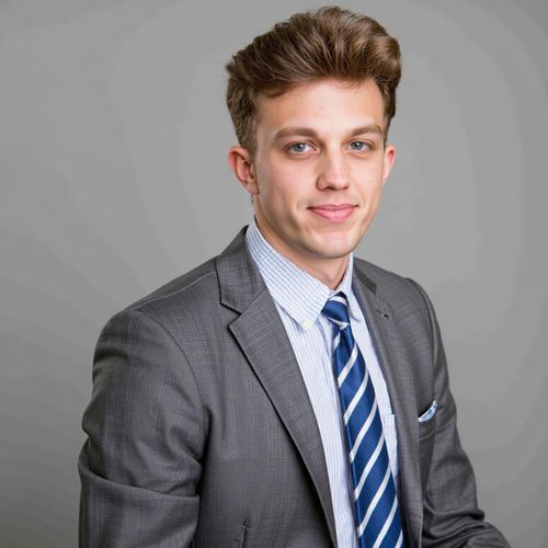 Showcase image for Future Leader - Prompt: a photo of me MAN in smart attire, medium shot, looking confident and determined, yearbook style. MAN with a strong, assured gaze.