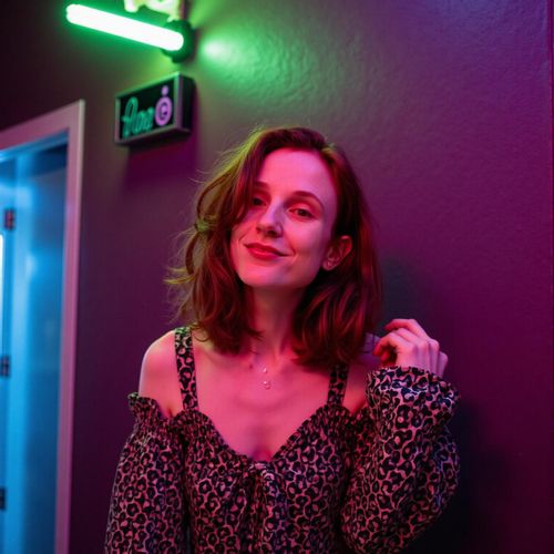 Showcase image for Night Out - Prompt: a photo of me WOMAN under neon lights, medium close-up, vibrant and energetic. WOMAN looking ready for a night on the town.