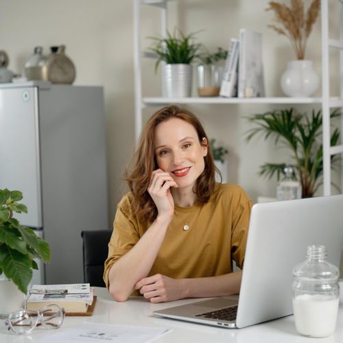 Showcase image for My Desk Shot - Prompt: a photo of me WOMAN seated at their clean, organized desk, medium shot, looking directly at the camera. WOMAN looking focused and efficient.